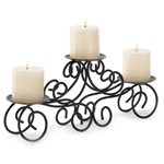 For instant decorating magic, look no further than this curvy candle stand! Elegantly fashioned from wrought iron scrolls, this triple-candle decoration make a gracious focal point atop your mantle, table or shelf. Spike bottoms.