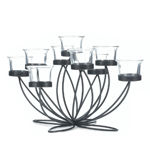 Gorgeous glow and sleek black iron create a dramatically gorgeous centerpiece for your table. The black iron framework blooms upward, holding nine clear-glass candle cups that allow the light from your favorite candles shimmer with style. Candles not included. 