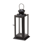 Turn the dark of night into star light with this beautiful candle lantern. Four clear glass panels are set into a rectangular metal frame that is finished in white or black and topped with starry cutouts and a hanging loop. 