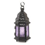 Shades of violet, lavender and purple will dance across your tabletop when you light a candle inside this exotic metal candle lantern. It features a black frame with intricate cutouts and six purple glass panels that turn candlelight into dazzling glow. Candle not included. 