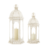 Where graceful design and vintage patina meet, youll discover these beautiful candle lanterns. The frame is iron, finished in distressed vintage-style white, and the clear glass panels let the light from your favorite candle shine bright. This lantern features a cutout pattern on the bottom and scalloped iron embellishments on the glass panels. 