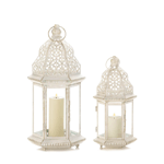 A little bit of candlelight will go a long way when you light your favorite candle inside this beauty. The iron frame has a vintage white finish that perfectly showcases the intricate cutout details and flourishes. Candle not included. 
