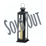 Candlelight and dramatic design will fill your space when you bring this incredible lantern home. Its angular black iron framework is striking, and the clear glass panels are ready to showcase the shimmering light from your favorite candle. The top has star cutouts and a hanging loop.