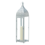 Bring global design elements into your home with this Moroccan-style candle lantern. It features an intricate cutout pattern on top with clear glass panels, and can be hung from the top loop or simply set on your table. Place a candle of your choice inside to bask your room in a soft and sultry glow. Candle not included.