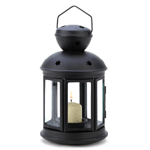 Quaint colonial styling and a sleek, modern matte black finish make this lamp a winning addition to your décor! Your favorite votive candle looks lovely at center stage behind six clear glass panels; just the right accent to make any evening into a special occasion.