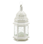 Candlelight shines from the cutout design of this lovely, lacy ivory lantern! It's hexagonal hurricane shape in creamy ivory is stunning against lush garden greenery, casting a gracious golden glow on a twilit summer's night.