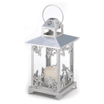 Gleaming silver finish and graceful scrollwork lend old-fashioned opulence to a classic candle lantern. An elegant decoration to enjoy, night and day! Also makes an artistic display for your favorite small houseplant or miniature figurine.