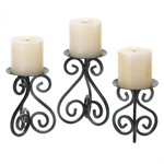 Thick, black iron rods curl and bend to create three beautiful pedestals for the lucky pillar candles of your choice. Each stand of this trio is a different height, and when placed together they create a visually stunning display of candlelight. This set is perfect for your mantel or even as the centerpiece of your table.