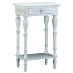 Curvy legs and shell-design trim add distinction to this square side table. A generous drawer and a bottom shelf provide plentiful storage. Wood with distressed white finish. Distress look will vary.
